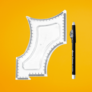 Clear plastic beard shaping template tool and white marking pencil for symmetrical facial hair grooming on a yellow background.