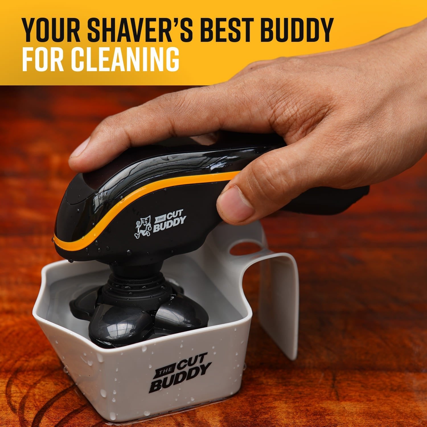 A hand holding The Cut Buddy shaver and its custom cleaning cup, with text emphasizing maintaining peak performance and preventing blade buildup.