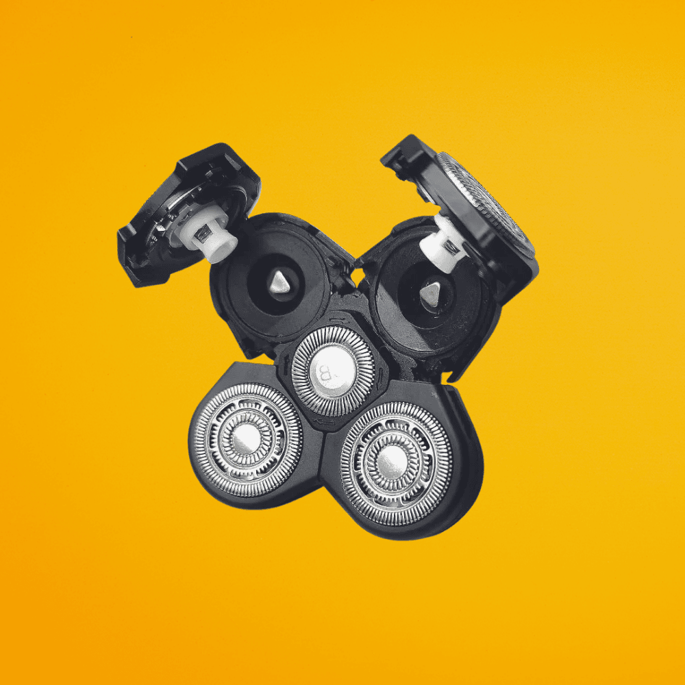Replacement 5-head rotary shaver blade attachment for The Cut Buddy, featuring a hinged open design for easy cleaning and debris removal.